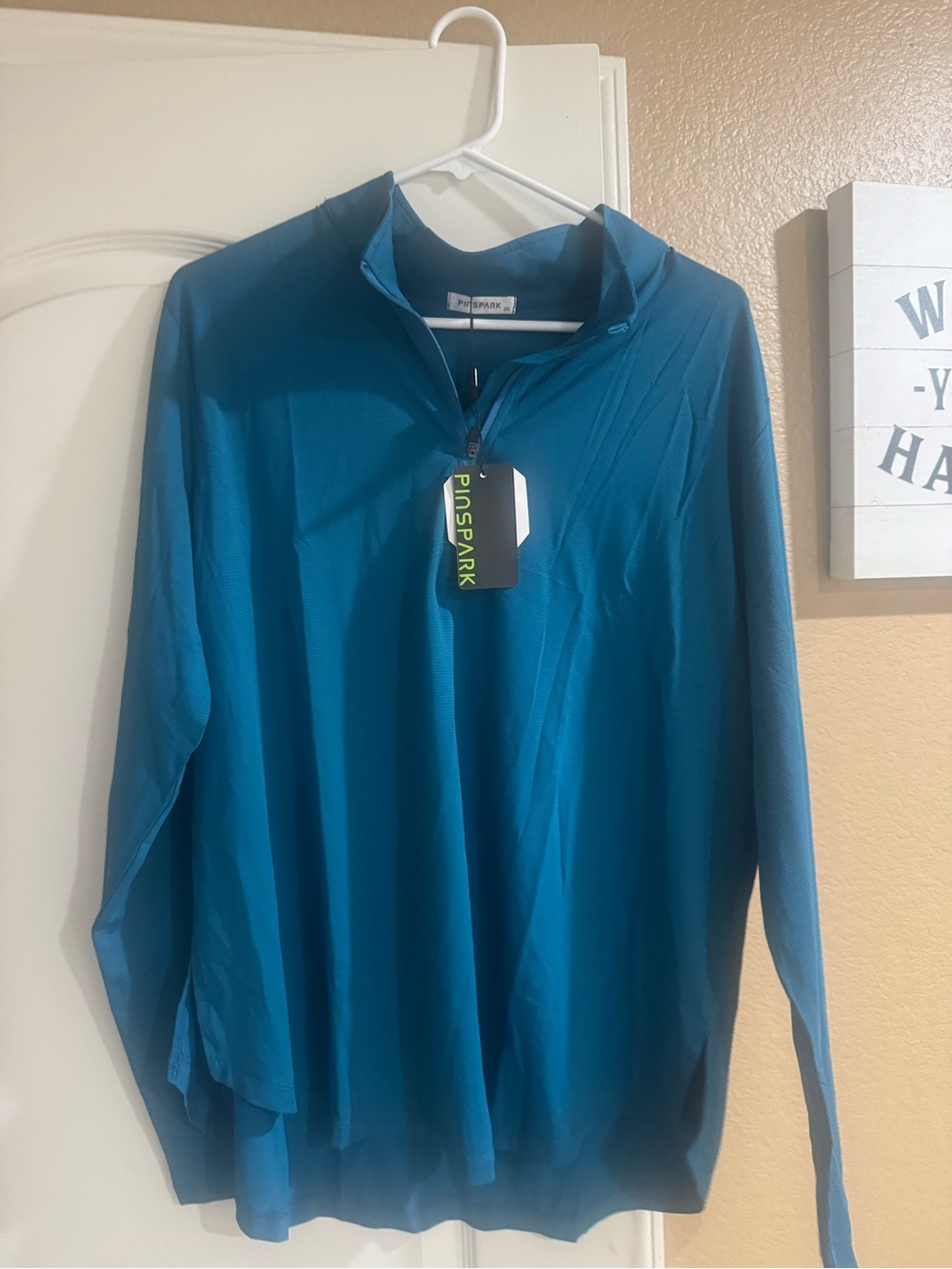 Woman’s Teal Quarter-Zip Performance Shirt